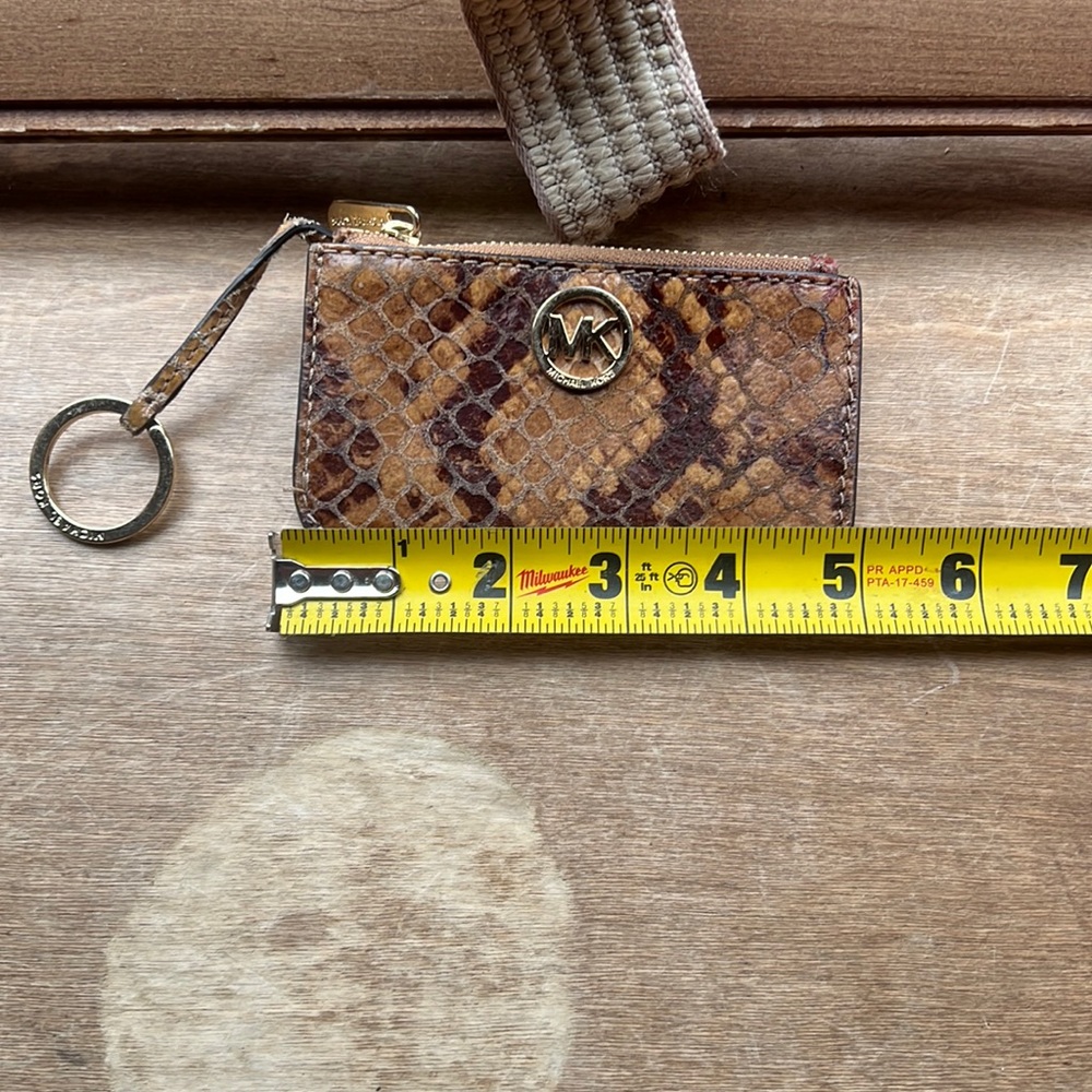 Michael kors key chain wallet, barely used. Small red stain from storage